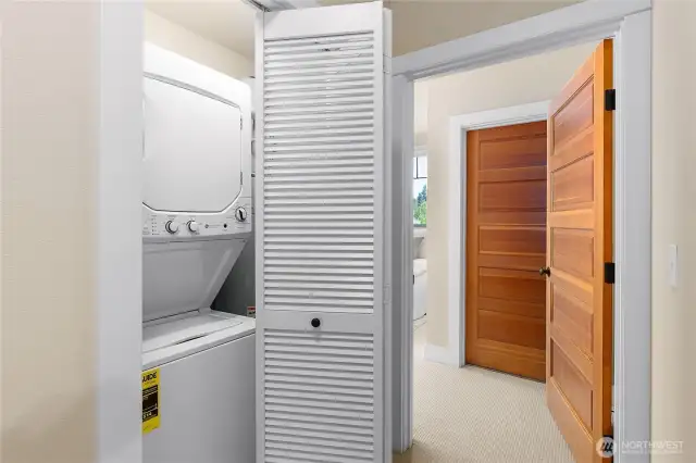 New washer and dryer discreetly tucked away in a hallway closet for easy access and a clean, streamlined look.