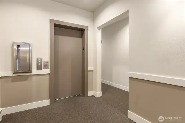 Conveniently located kitty-corner to the elevator, with easy access to the covered garage—no stairs required.