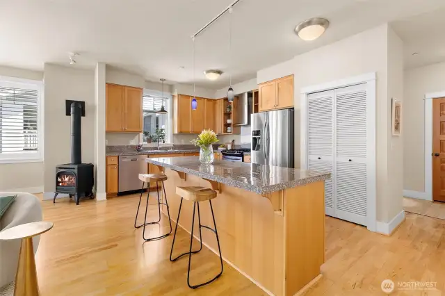 Modern kitchen featuring stainless steel appliances, well-maintained Craftsman-style cabinetry, and a functional layout that opens to the great room.