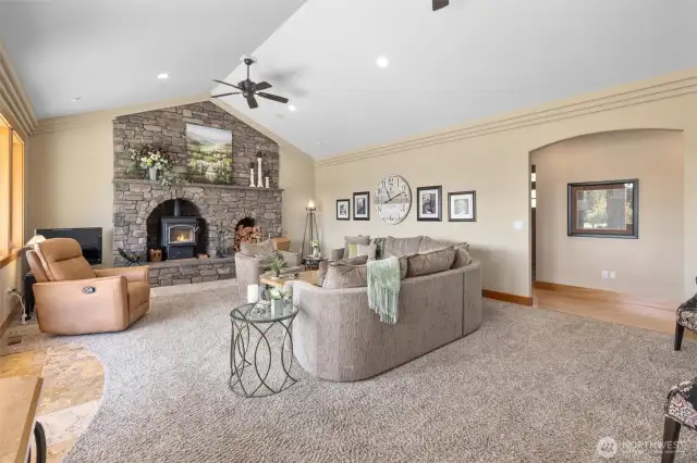 Off the kitchen is the living room with huge stone fireplace/hearth surround. This is a free standing fireplace that throws so much heat!!! Notice the coffered ceilings!!!