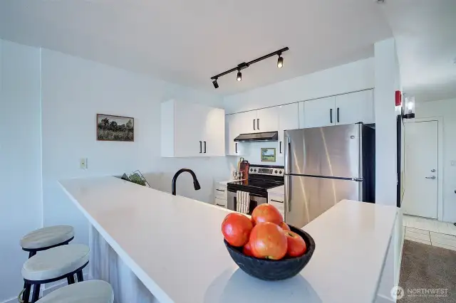 Newly remodeled kitchen has new cabinetry and quartz countertops.