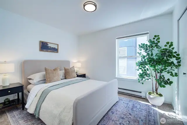 Primary bedroom staged with a queen size bed.