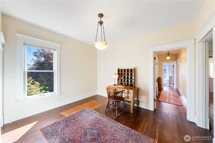 From the entryway Foyer, this Office space has a large closet on the left.  The main level hallway leads to the bathroom on the left with the bedroom at the end of the hall.  The doorway on the right leads to the living room.