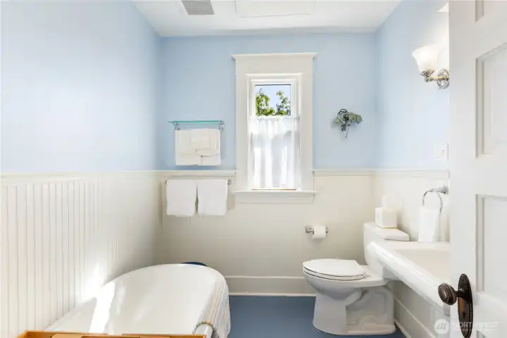 Look at this sweet bathroom!  There is a heating panel on the ceiling to keep you toasty warm. This is the original claw foot tub with other built ins.