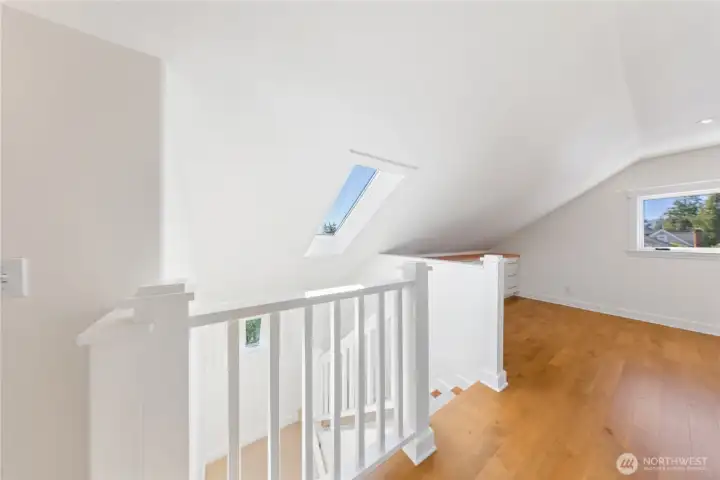 Light, bright stairs to the upper level.  That space at the end is perfect for an Art Studio, Quilting, Painting or Crafts or Hobbies. There are built in cabinets of storage.