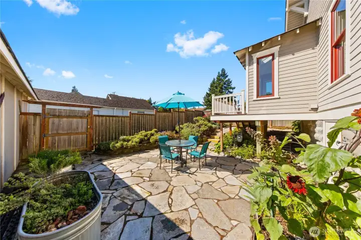 The Utility/Sunroom opens onto the Deck with steps to the Professional Landscaped Park-Like grounds.  Its fully fenced for privacy.  There is Gate access to the Alley access.