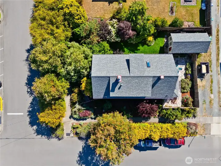 Situated perfectly for a Master Gardner who want to walk to town and have privacy.  Look at all the extra parking space off the alley.  You could easily park an RV, Truck or Boat in that space that currently has a Utility Trailer parked.  There is another private seating area in the front yard corner near the the front Porch.