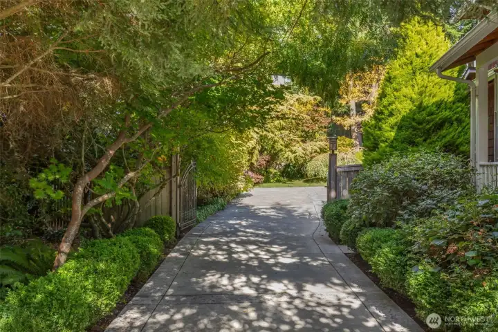 The welcoming drive is carefully landscaped, providing a stunning entrance to the courtyard.