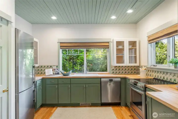 Clean lines, great layout, butcherblock countertops make for a wonderful cooking experience, lots of light views to the garden enjoy the openess of this well thought out kitchen.