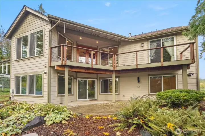 House with deck above, accessible from Mstr Bedroom and Living room.  Lower patio access from the Family Room.  Note the outdoor shower for easy cleanup when you get back from clam digging.