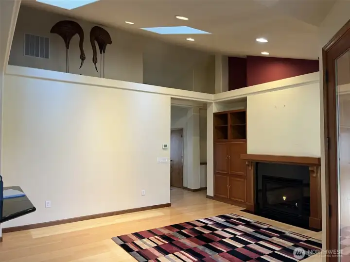 Come in from the entry to the vaulted ceiling living room. Master Bedroom to the back right.  Propane fireplace.  The wicker egrets on the shelf are optional.