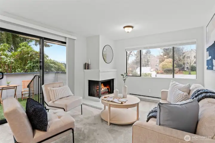 Large windows bring in natural light and showcase serene greenery outside.