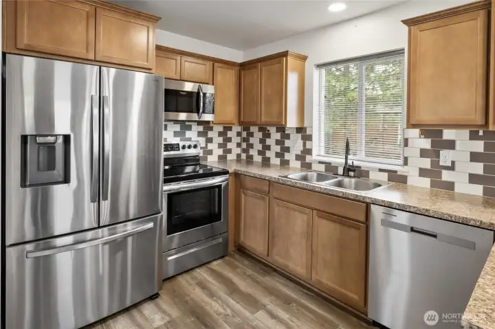 Kitchen with SS appliances.