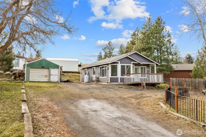 Driveway leads you to the home and 1-car garage with a workbench and storage space.