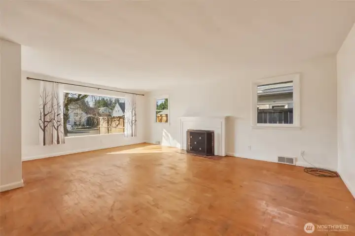 Large picture window into the living rooms brings in the afternoon light.