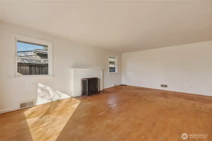 Picture hardwood floors restored to a gleaming finish, built-in shelving around the fireplace - l