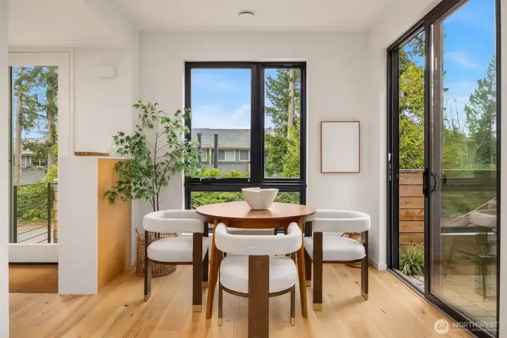 The dining room offers wonderful access to the front patio with a large sliding glass door, seamlessly blending indoor and outdoor living and creating an inviting space for al fresco dining and entertaining.