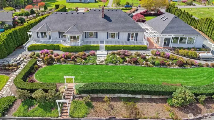 What distinguishes the space is its connectivity. The decks extend the home outward, offering platforms of pause and perspective, while paths - crafted in stone, gravel and finely set pavers - gently link one moment to the next.