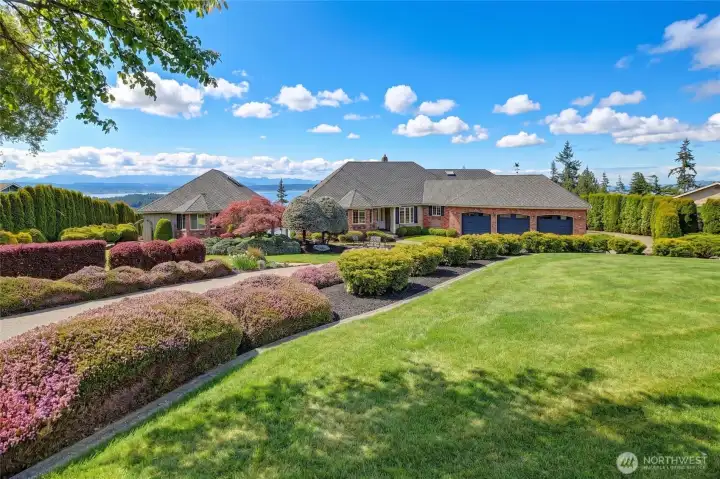 The approach begins with a quiet sense of order, where the landscape feels not imposed, but composed. The circular drive unfolds with measured grace.