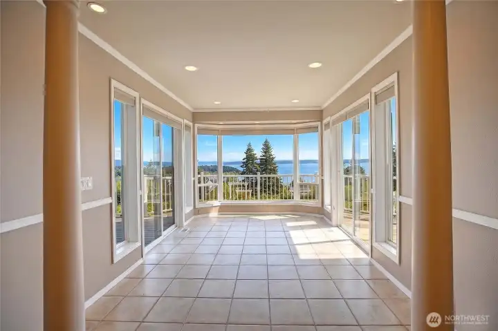 Just beyond the kitchen, a room unfolds that feels like an unveiling offering an uninterrupted 180-degree panorama that shifts with the hour and the season. It's a living canvas, always in motion, always in dialogue with the space it surrounds.