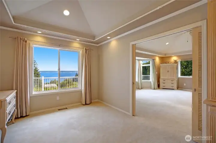 A graceful transition room bridges the home's shared spaces and the primary bedroom, offering a quiet moment of pause along the way.