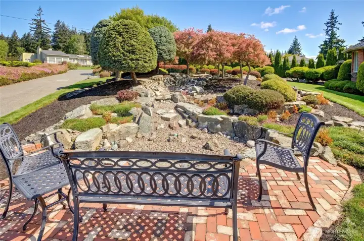 At the end of the water feature, the sitting area feels calm and settled.