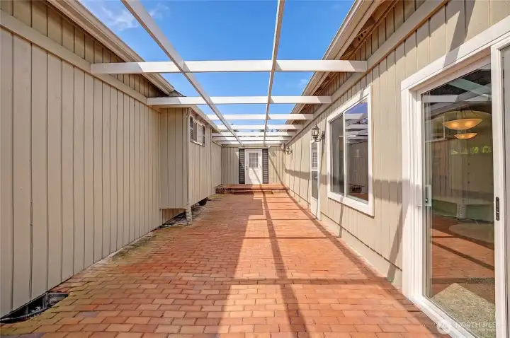 The space between the home and auxiliary building feels intentional. It opens just enough to create breathing room - allowing light and air to move freely between the two structures.