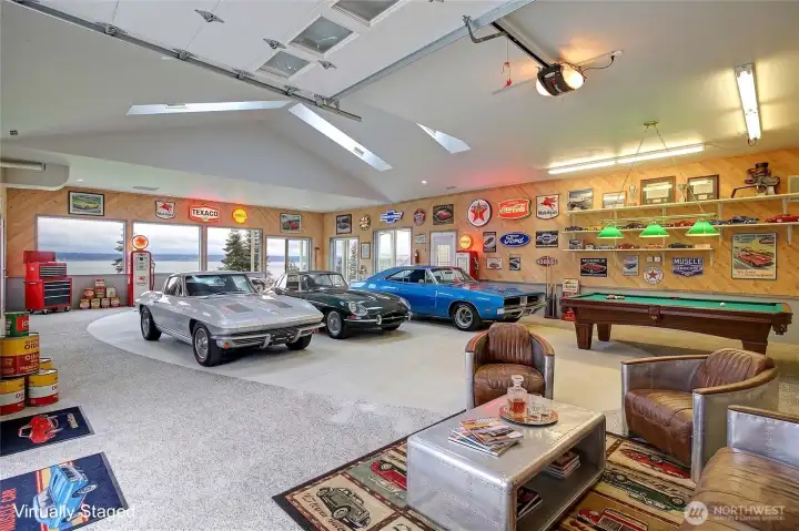 A versatile 1,665 sq ft auxiliary building steps to the main house once housed an indoor pool and spa. Today the space offers room to create, tinker, and dream without limits. The open layout can easily adapt to any passion- whether it's a workshop, art studio, fitness area, or creative retreat - while still leaving space to stay organized and uncluttered. Large windows to the view keeps the environment inspiring and functional, and generous wall space allows for storage, shelving, or displays.  The space features a full size roll up garage door, 2 sliders, single access door, and a half bathroom.  It's a place where projects can spread out, ideas can evolve, and hobbies can truly take shape - flexible enough to change with your interests and spacious enough to bring them to life.