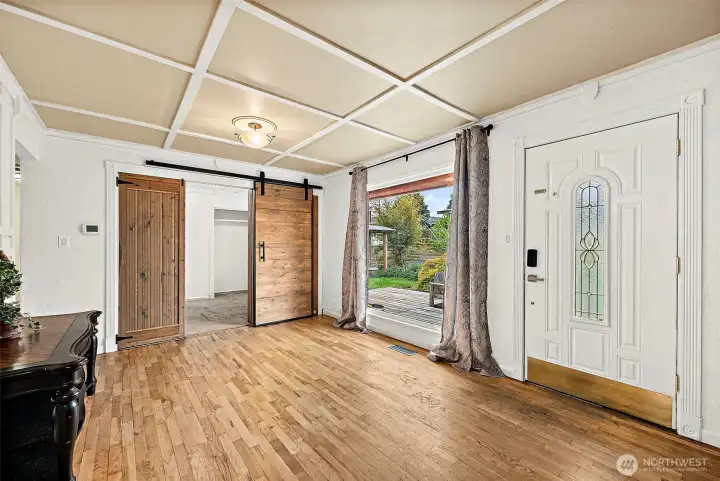 Front room with massive picture window floods the room with light. Beautiful hardwood floors add to the charm and character of this single owner home of 49 years. Sliding barn door of foyer leads to front bedroom.