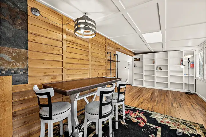 Dining space and more  with a whole wall of built-in shelving to fill with collectables, cook books, fine china, or whatever your heart fancies.