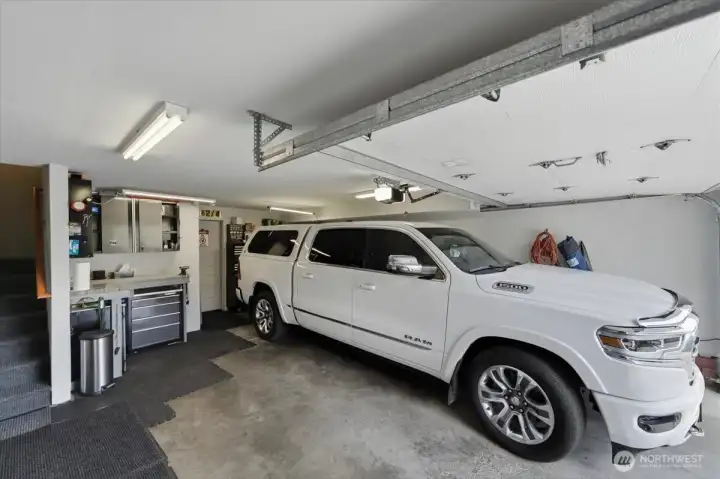 Garage with storage cabs and work bench.  Tool chest and cabinets over work bench not included.