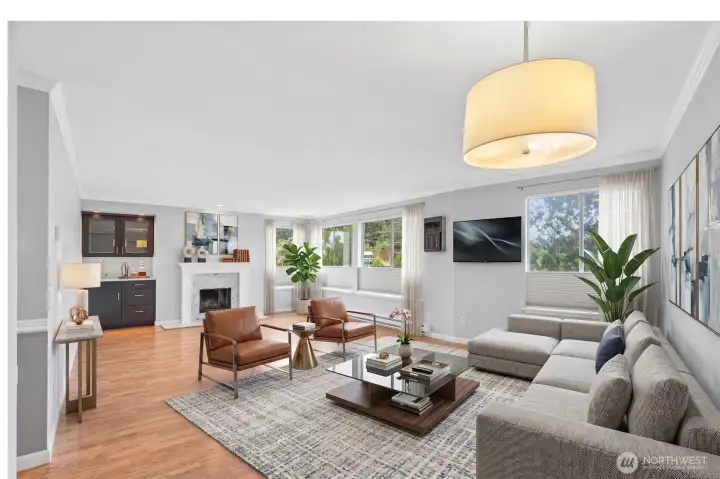 Bright and open living/dining area with pendant lighting and beautiful hardwood floors.