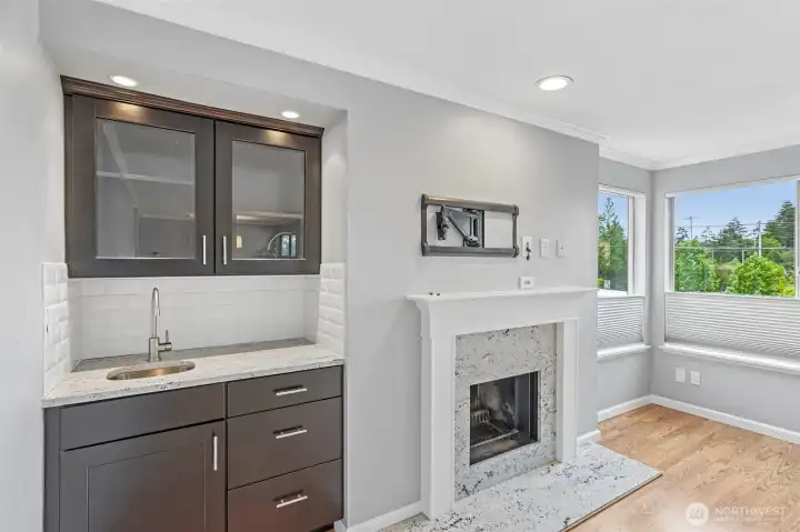 Cozy living area with a handsome fireplace and wall-mounted TV — perfect for relaxing evenings.