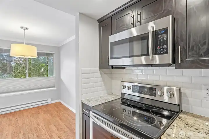 Modern kitchen with stainless steel appliances, pendant lighting, and clean contemporary lines.