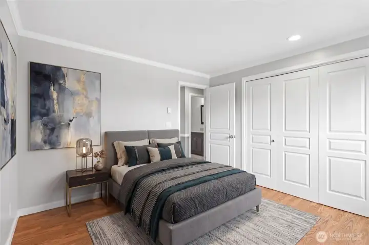 Spacious primary bedroom with crisp white closet doors and room for a king-size suite.