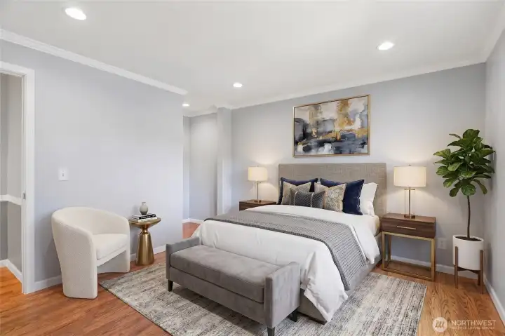 Inviting primary suite with a stylish upholstered bed and sophisticated neutral tones.