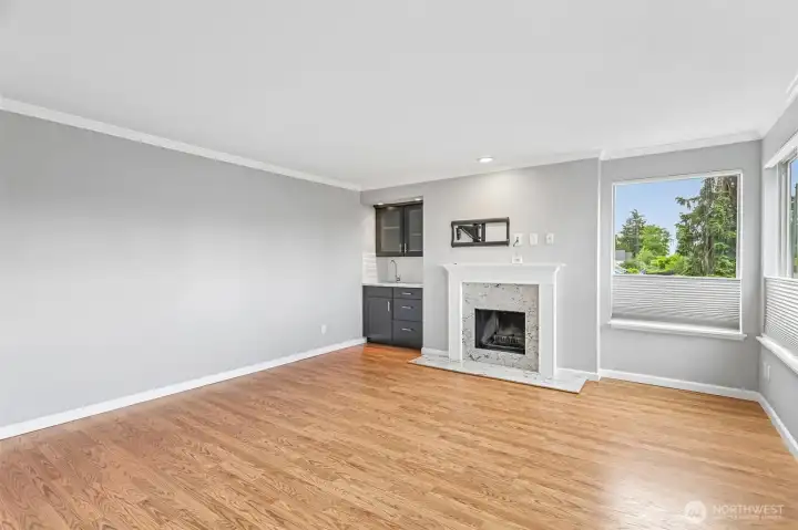 Comfortable living room with a classic fireplace and gleaming hardwood floors.