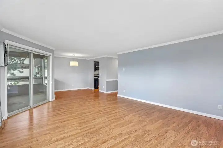 Graceful hallway with rich hardwood floors flowing through the open-concept layout.