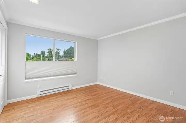 Flexible den or office space with warm hardwood floors and a serene outlook.