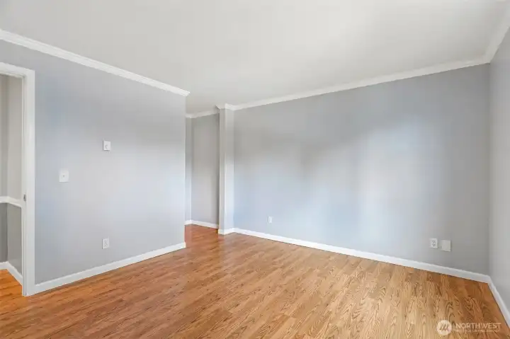 Sun-drenched living room with warm hardwood floors and a bright, open feel.