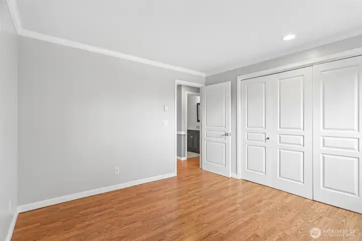Well-organized hallway closet with clean white bi-fold doors and ample storage.