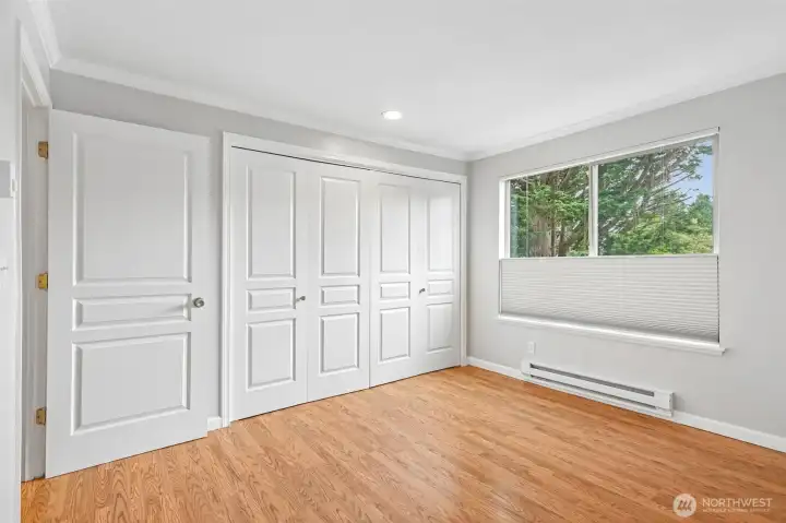 Spacious closet with bi-fold doors and natural light — a rare find in condo living.