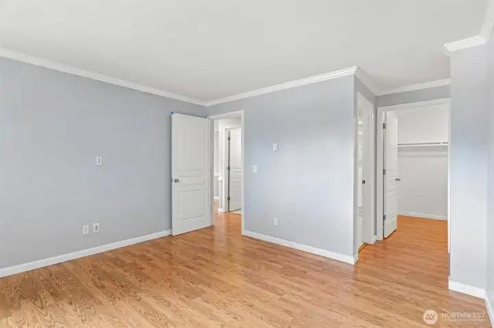Immaculate room with fresh white walls and a classic solid wood door.