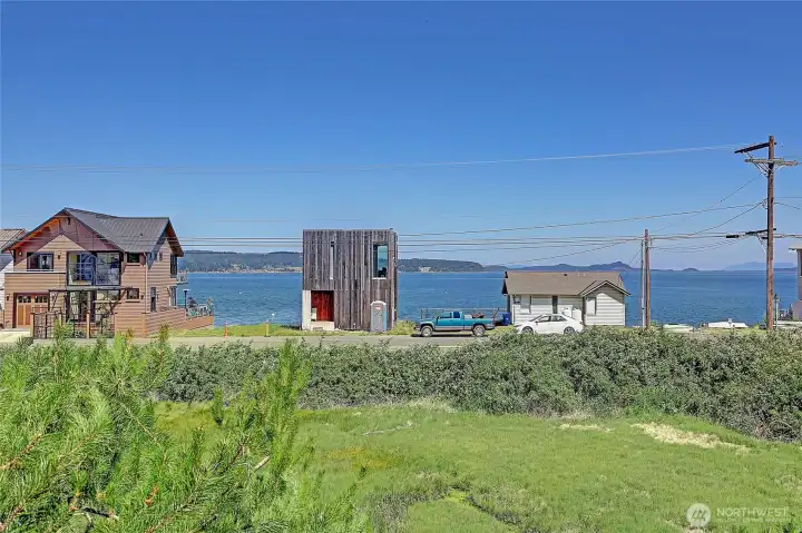 Lot in front of Condo is owned by Island Co for drainage/wetland.