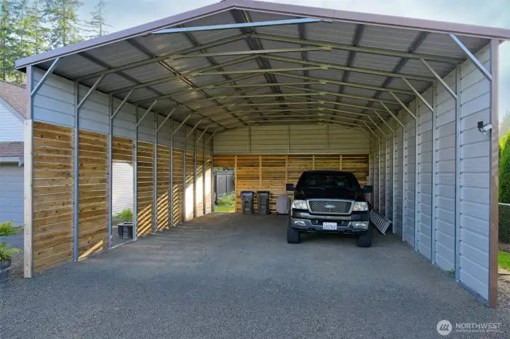 Enormous 24x36x14 partially enclosed detached carport. Enormous 24x36x14 partially enclosed detached carport.