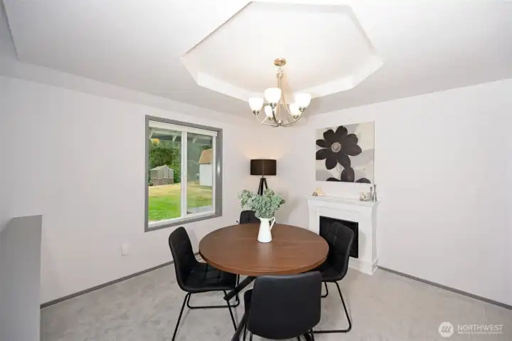 Dining room right off the kitchen with coffered ceiling and electric wood fireplace. Dining room right off the kitchen with coffered ceiling and electric wood fireplace.
