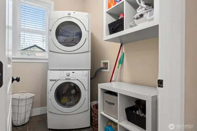 The laundry room is conveniently located off the kitchen and near the door leading out to the garage.