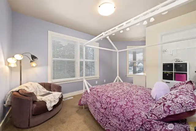 This upper floor bedroom looks out to the rear and side yard and has its own walk-in closet.