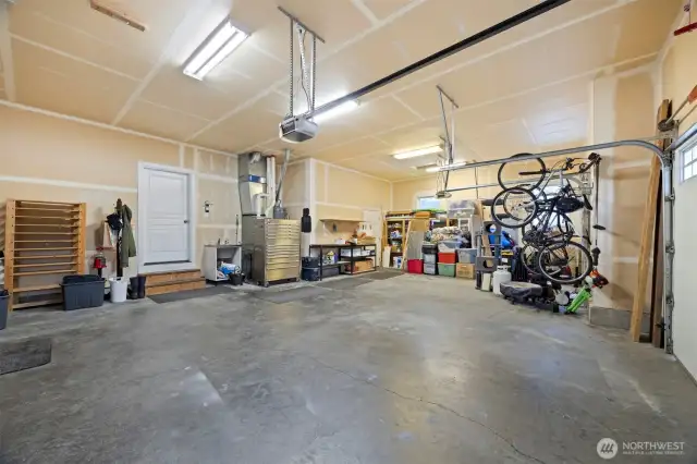 Looking toward the door that opens to the kitchen in the 3 vehicle garage. The gas forced air furnace and hot water heater are just to the right of the door.