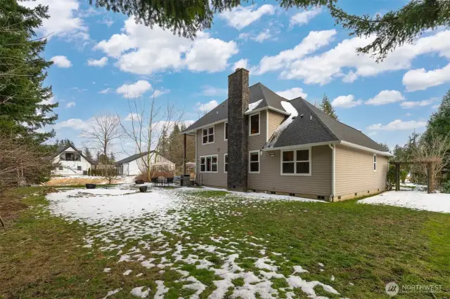 Another view of the rear of the home and the large, level yard.